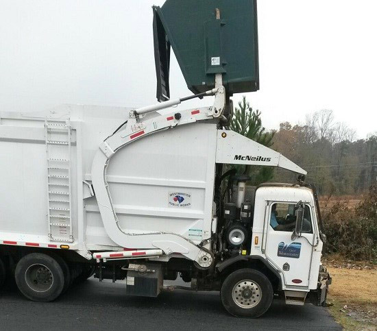 Westminster garbage truck collecting a dumpster